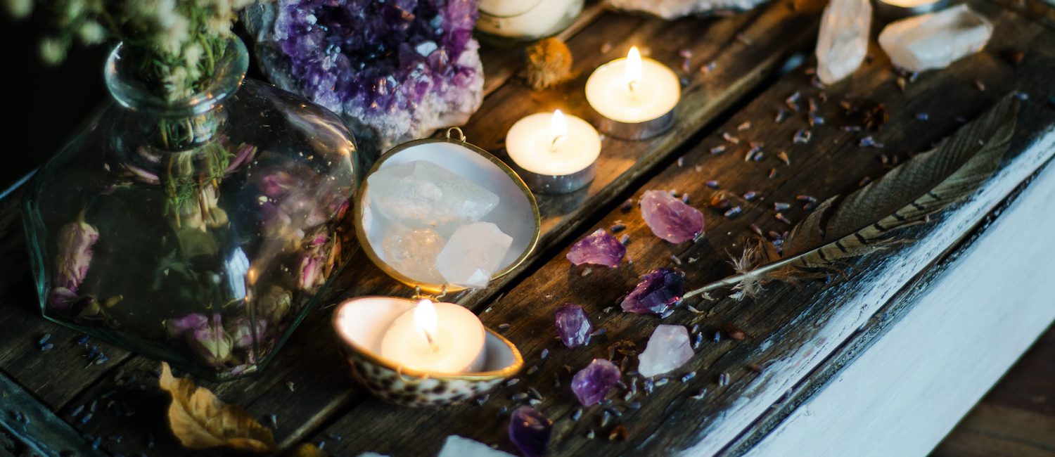 Candles and crystals on display at home.