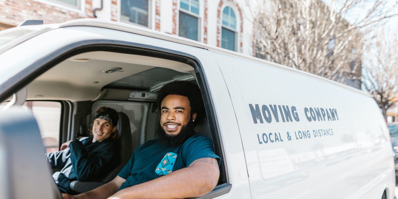 happy movers in a white van
