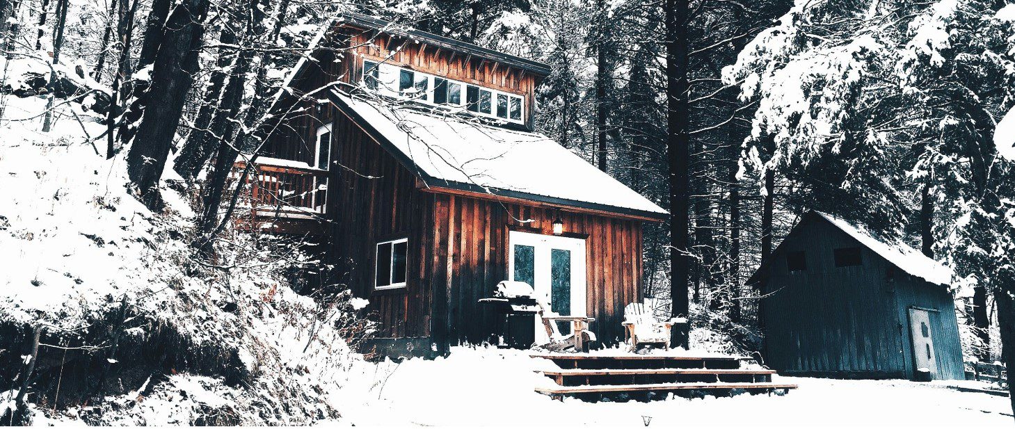 Small cozy house covered in snow during the winter