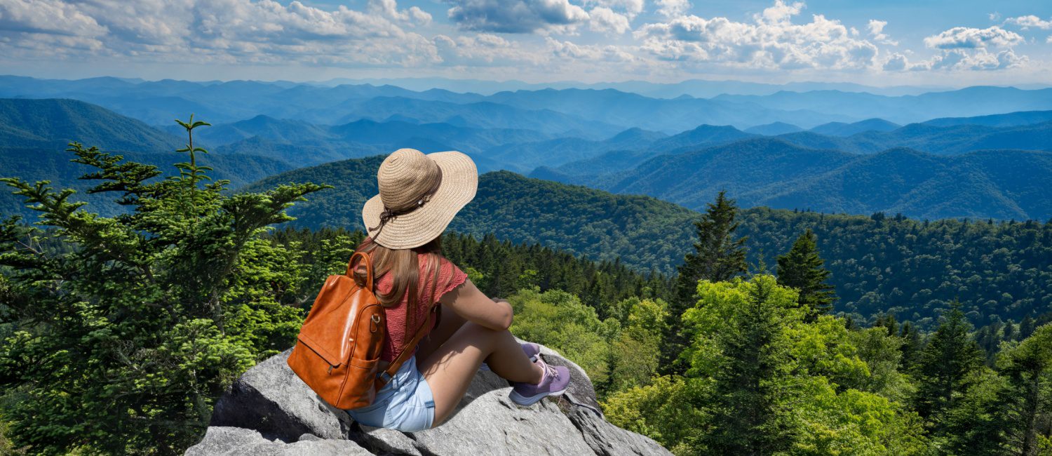 Woman looking out over Asheville, North Carolina, from a scenic overlook