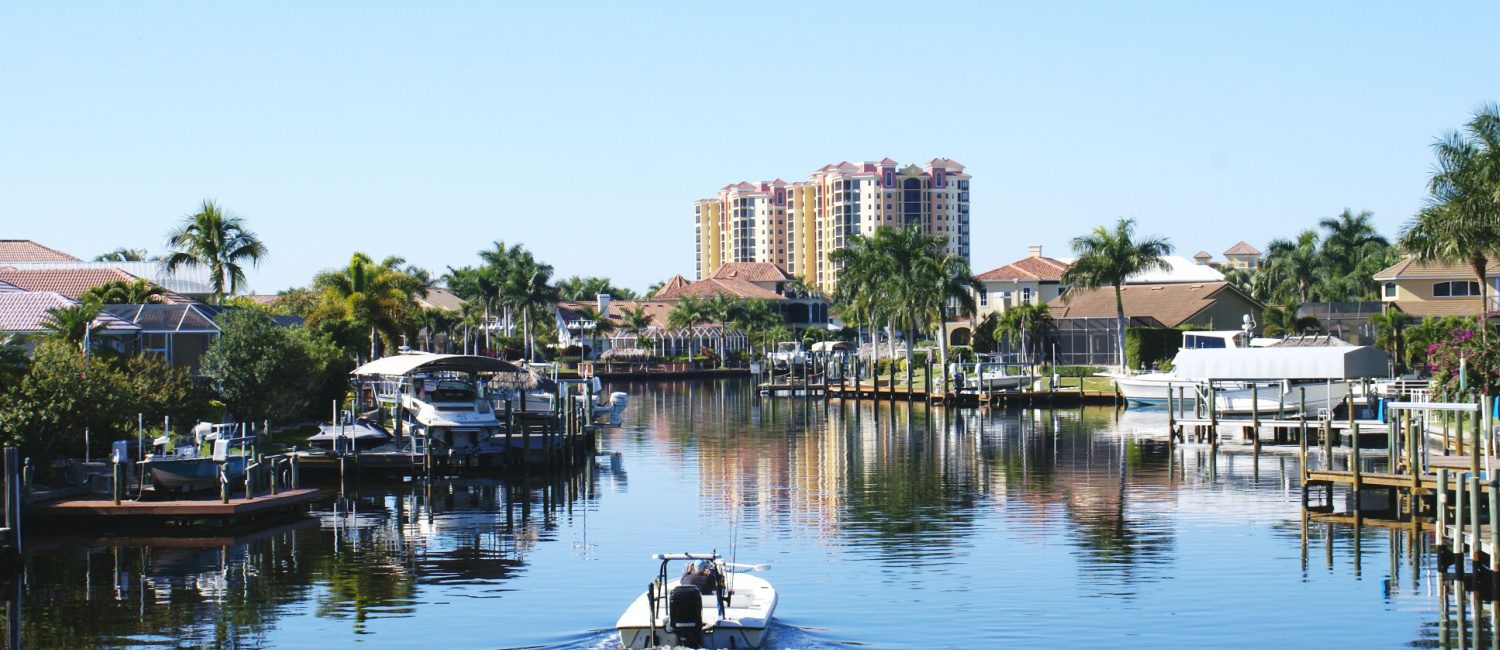 Boater on a canal in Cape Coral, a Florida city filled with pros and cons